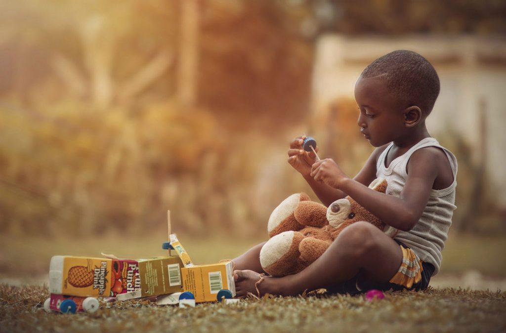 jamaican child playing toy truck